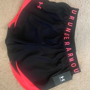 Under Armour workout shorts. Black with orange detail, size small. NWT